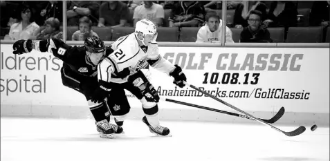  ?? — Photo by The Associated Press ?? Los Angeles Kings’ winger Matt Frattin moves the puck ahead of Anaheim Ducks’ defenceman Ben Lovejoy during pre-season NHL action in Anaheim, Calif., on Tuesday night. Frattin, who came to L.A. from Toronto in the trade that sent goalie Jonathan...