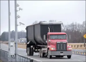  ?? NWA Democrat-Gazette/J.T. WAMPLER ?? A truck passes the virtual weigh-in-motion station on Arkansas 64 in Alma. The virtual technology measures such things as a truck’s weight and speed.