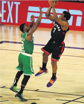  ?? PHOTO: USA TODAY SPORTS ?? Clutch time . . . Toronto Raptors guard Kyle Lowry (right) shoots against Boston Celtics guard Kemba Walker in double overtime in game six of their Eastern Conference semifinal series near Orlando yesterday.