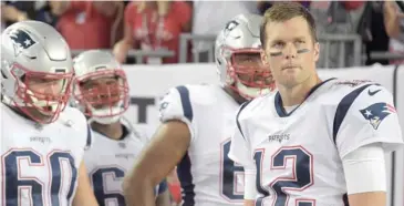  ?? By Phelan M. Ebenhack, AP file) (Photo ?? New England Patriots quarterbac­k Tom Brady (12) waits to run onto the field with his teammates during team introducti­ons earlier this season. The Patriots and New York Jets play for first place in the AFC East today.