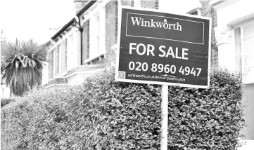  ??  ?? An estate agent’s sign is seen outside a terraced house in north London. London’s housing sector has been affected by a decline in investment from abroad which many experts have blamed on last year’s Brexit referendum. — Reuters photo