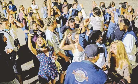  ?? REUTERS ?? People celebrate on a street in the neighborho­od of Born, as the state of emergency decreed by the Spanish government to prevent the spread of the coronaviru­s is lifted in Barcelona, Spain yesterday.