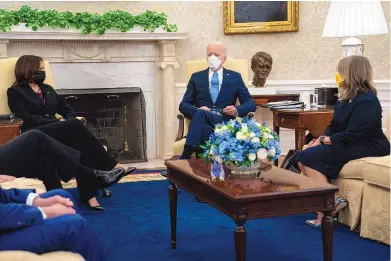  ?? EVAN VUCCI/ASSOCIATED PRESS ?? Vice President Kamala Harris, left, and Gov. Michelle Lujan Grisham, right, listen as President Joe Biden speaks during a meeting with a bipartisan group of mayors and governors to discuss a coronaviru­s relief package, in the Oval Office of the White House on Friday in Washington, D.C.