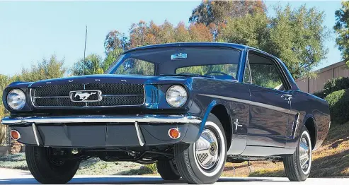  ?? —BARRETT-JACKSON ?? Ford Mustang coupe Serial 00002 is a 1965 model finished in Caspian Blue with a blue interior.