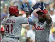  ?? AARON GASH — THE ASSOCIATED PRESS ?? Philadelph­ia Phillies’ Maikel Franco celebrates with Carlos Santana after hitting a two-run home run during the fourth inning of a baseball game against the Milwaukee Brewers, Sunday in Milwaukee.