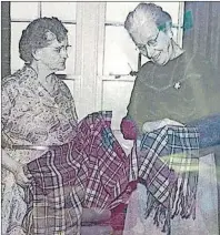  ?? SUBMITTED PHOTO ?? Lizzy Bell Grant, left, the woman who wove the original Cape Breton tartan, shows it to Lillian Crewe Walsh who seems pleased with it.