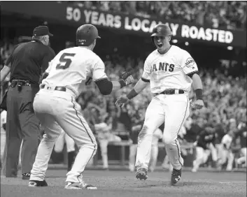  ?? BEN MARGOT/THE ASSOCIATED PRESS ?? Joe Panik, right, celebrates with Giants teammate Matt Duffy after scoring the winning run in San Francisco’s 5-4, 10-inning victory over the Dodgers on Saturday at AT&T Park.