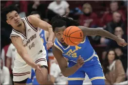  ?? JEFF CHIU — THE ASSOCIATED PRESS ?? Stanford’s Spencer Jones and UCLA’S Sebastian Mack battle for a loose ball during the second half of Wednesday’s Pac-12game at Stanford. UCLA won 82-74.