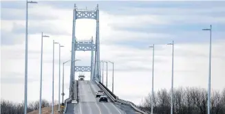  ?? REUTERS/CHRISTINNE MUSCHI ?? A truck drives over the Seaway Internatio­nal Bridge from the U.S. into Canada after movement restrictio­ns came into effect due to coronaviru­s disease (COVID-19) on Cornwall Island, Ont. on March 25.