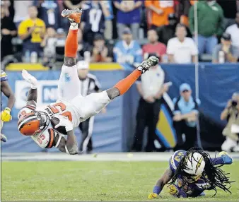  ?? [JAE C. HONG/THE ASSOCIATED PRESS] ?? Browns tight end David Njoku is upended by Chargers free safety Tre Boston after making a catch in the second half.