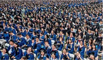  ?? — AFP ?? Nearly 11,000 graduates, including more than 2,000 students who could not attend the graduation ceremony last year due to the Covid-19 outbreak, attend a graduation ceremony at Central China Normal University in Wuhan, in China’s central Hubei province.