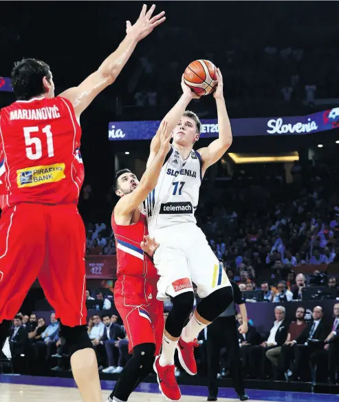  ?? LEFTERIS PITARAKIS / THE ASSOCIATED PRESS ?? Slovenia’s Luka Doncic, right, is the consensus No. 1 pick heading into the NBA entry draft. But with a rich free-agent class and teams looking to shed payroll, there could be plenty of movement that impacts Doncic’s placement.