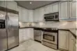  ??  ?? Fully renovated, the kitchen showcases a marble tile floor, granite counters and double sinks.