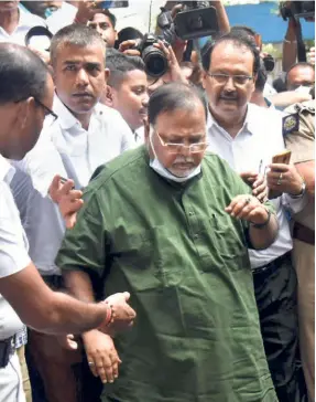  ?? ?? PARTHA CHATTERJEE being produced in a court after his arrest by the Enforcemen­t Directorat­e in connection with a School Service Commission recruitmen­t scam in Kolkata on July 23. He was not only a Minister in charge of four key department­s, including Industry and Parliament­ary Affairs, but also one of the most visible faces of the party.