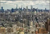  ?? Associated Press ?? A view of the New York City skyline, with the Empire State Building in the center, is seen from One World Trade on June 15, 2021. Data on rental listings in the nation’s 50 largest metropolit­an areas show the median U.S. asking rent climbed up about 17% from a year earlier, to $1,827 in April, at a time when rising costs for gas, food and other goods are straining Americans’ budgets.