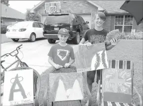  ?? MARK HUMPHREY ENTERPRISE-LEADER ?? Tristan Hall, 10 (left) and Ethan Mallard, 15, of Farmington, display paintings, made by Tristan as a fundraiser on behalf of his “Meme,” grandmothe­r Deb Majors, who is battling cancer. The boys operated a lemonade stand and sold paintings in July...
