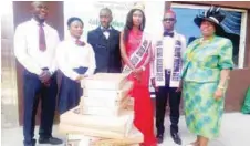  ??  ?? Justice Ayodeji Balogun and Mrs Balogun with beneficiar­ies during the donation of 25 new laptops worth N2.5million to 25 blind students