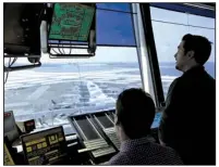  ?? AP/SETH WENIG ?? Air traffic controller­s work in the tower at John F. Kennedy Internatio­nal Airport in New York on Thursday. President Donald Trump is calling for privatizin­g the nation’s air traffic control operations in his budget proposal, a top priority of the...