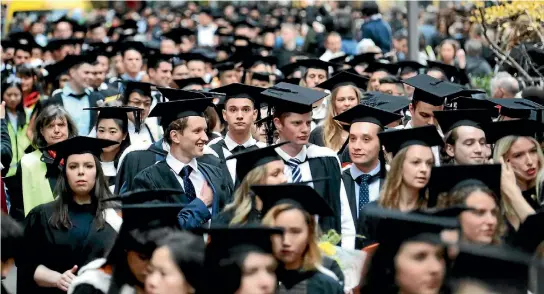  ?? PHOTO: CAMERON BURNELL/STUFF ?? Graduates, of both arts and other discipline­s, parade in the street.