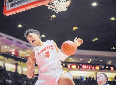  ?? ROBERTO E. ROSALES/JOURNAL ?? UNM freshman Tavian Percy dunks the ball against Northern New Mexico College earlier this season in Dreamstyle Arena - The Pit. He and two other Lobos freshmen are seeing their roles increase for UNM as the season progresses.