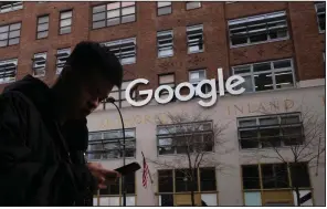  ??  ?? A man using a mobile phone passes Google offices in New York in this file photo. (AP)