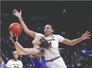  ?? The Associated Press ?? GAME OPPONENTS: South Carolina’s Mikiah Herbert Harrigan (21) defends as Buffalo’s Stephanie Reid (1) shoots during the second half in the Gamecocks’ 79-63 Albany Region semifinal victory Saturday in New York.