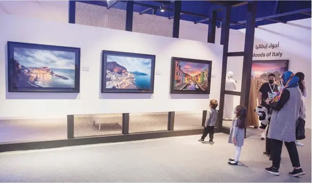  ?? Kamal Kassim/gulf Today ?? ↑
Visitors view some exquisite photograph­s at the Xposure exhibition in Sharjah.