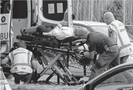  ?? MARK BAKER • AP ?? Ambulance staff take a man from outside a mosque in central Christchur­ch, New Zealand, Friday.