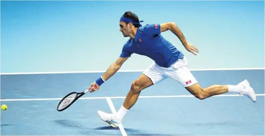  ?? PHOTO: GETTY IMAGES ?? Normal transmissi­on resumes . . . Swiss Roger Federer reaches to play a volley in his ATP Finals match against Dominic Thiem in London yesterday. Federer easily beat the Austrian 62, 63.