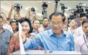  ?? AFP ?? Cambodia's Prime Minister Hun Sen (centre) casts his vote.