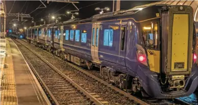  ?? SCOTRAIL. ?? Three-car 385001 stands at Linlithgow in the early hours of October 18, having completed the first test run from Edinburgh Waverley. This was as far as the electric multiple unit (EMU) ran on the newly-electrifie­d route between the Scottish capital and...