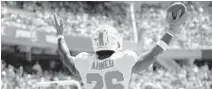  ?? DAVID BANKS/AP ?? Dolphins running back Salvon Ahmed celebrates his touchdown against the Bears last week in Chicago.