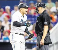  ?? DANIEL A. VARELA dvarela@miamiheral­d.com ?? Marlins outfielder Avisaíl García argues after being called out on a questionab­le third strike by umpire Lance Barrett.