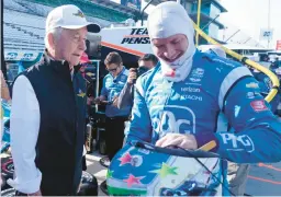  ?? DARRON CUMMINGS/AP ?? Roger Penske, left, talks with Josef Newgarden before a practice session Friday for the IndyCar race at Indianapol­is Motor Speedway in Indianapol­is.