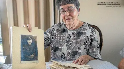  ?? WARWICK SMITH/STUFF ?? Joan Mackenzie holds a picture of her father, John Christense­n.