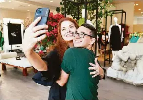  ?? Craig Barritt / Getty Images ?? Debra Messing and Christian Siriano take a selfie at the opening of his store, THE COLLECTIVE WEST, on July 12 in Westport.