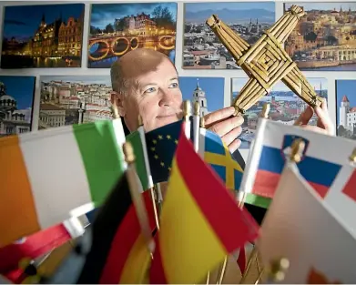 ??  ?? Irish ambassador Peter Ryan holds a St Brigid’s cross, commonly hung in Irish households to protect the home from harm.