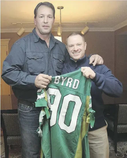  ?? BROCK SUNDERLAND ?? Dennis Byrd, left, was a hero to a young Brock Sunderland and a friend in later years before Byrd’s death in 2016. The two are holding the jersey cut off Byrd when he was paralyzed in a 1992 NFL game.