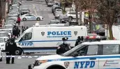  ?? Mark Lennihan / Associated Press ?? Police set up a perimeter Friday amid a shootout between U.S. marshals and a fugitive in New York.