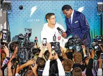  ?? PHOTOS BY AL DIAZ / MIAMI HERALD / TNS ?? San Francisco 49ers quarterbac­k Jimmy Garoppolo is interviewe­d by sports commentato­r Michael Irvin during Super Bowl Opening Night at Marlins Park in Miami, Fla.