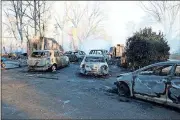  ?? Photos by Spencer Lahr, Rome News-Tribune ?? BELOW: These five cars in the driveway of the home are included in the significan­t damage caused by the fire.