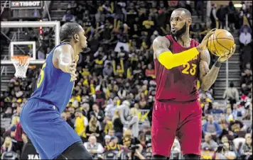  ?? JASON MILLER / GETTY IMAGES ?? Golden State’s Kevin Durant (left) and Cleveland’s LeBron James went against each other twice this season, with each team winning on its home floor. James holds an 18-5 career edge in games against Durant’s teams.