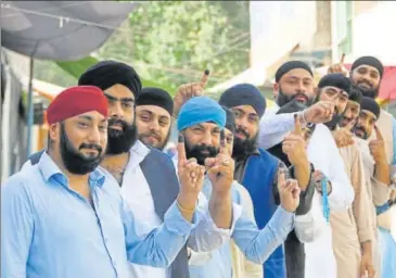  ??  ?? Afghan Sikhs show their inked fingers after casting their votes at a polling station in the city of Jalalabad, east of Kabul, on Saturday.
AP