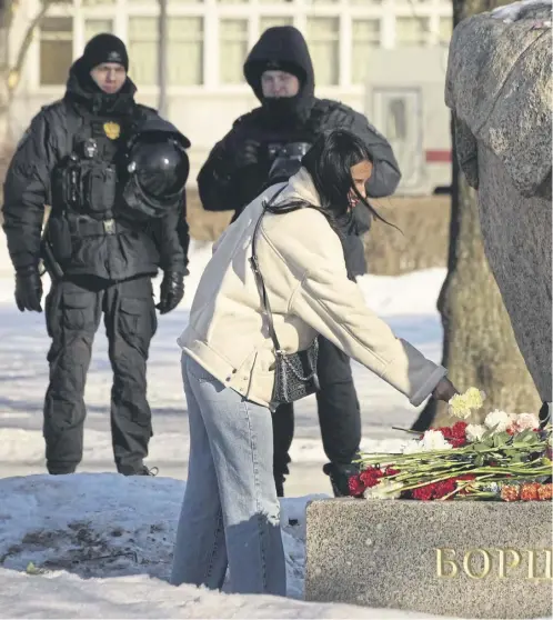  ?? ?? Hundreds of people in dozens of Russian cities have streamed to ad-hoc memorials and monuments to victims of political repression­s with flowers and candles to pay tribute to Russian opposition leader Alexei Navalny, right, who died at a remote Arctic prison colony on Friday