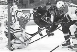  ?? ROSS D. FRANKLIN/AP ?? Stars goaltender Anton Khudobin (35) makes a save on a shot by Coyotes right wing Conor Garland, second from right, on Saturday.