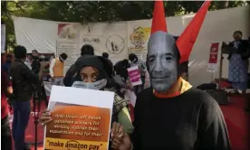  ?? Photograph: Manish Swarup/AP ?? Someone wears a mask of the face of the Amazon founder, Jeff Bezos, as they join other workers in a protest over pay and conditions in India.