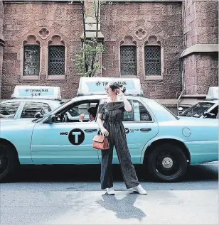  ??  ?? Renée Tse in New York City for the Tiffany Paper Flowers launch event in front of a Tiffany blue taxi.