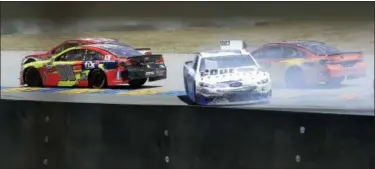  ?? BEN MARGOT — THE ASSOCIATED PRESS ?? Danica Patrick, center, slides between Dale Earnhardt Jr., left, and Clint Bowyer on turn seven during the NASCAR Sprint Cup Series auto race Sunday in Sonoma