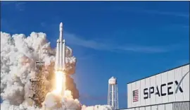  ?? Red Huber Associated Press ?? SPACEX’S Falcon Heavy rocket lifts off Feb. 6. Its center core booster didn’t land on a f loating sea platform because it ran out of ignition f luid, Elon Musk says.