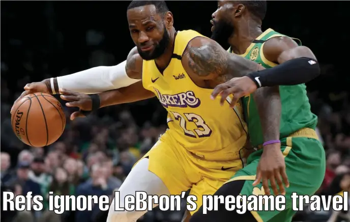  ?? JIM MICHAUD / HERALD STAFF ?? ‘I WALKED’: Los Angeles Lakers star LeBron James backs down Celtics guard Jaylen Brown on Monday night.